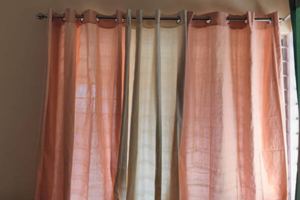 9KGgSJeEs3 Closeup of colorful orange cream window curtains in room interior indoors apartment
